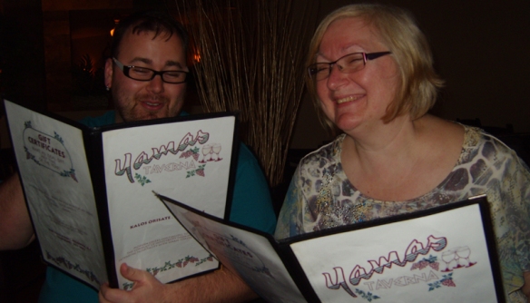 Csaba and Ella happily peruse the Yamas menu